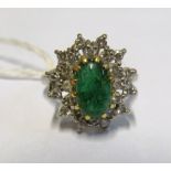 A cluster ring marked 18ct set green stone, size M 6.1gm