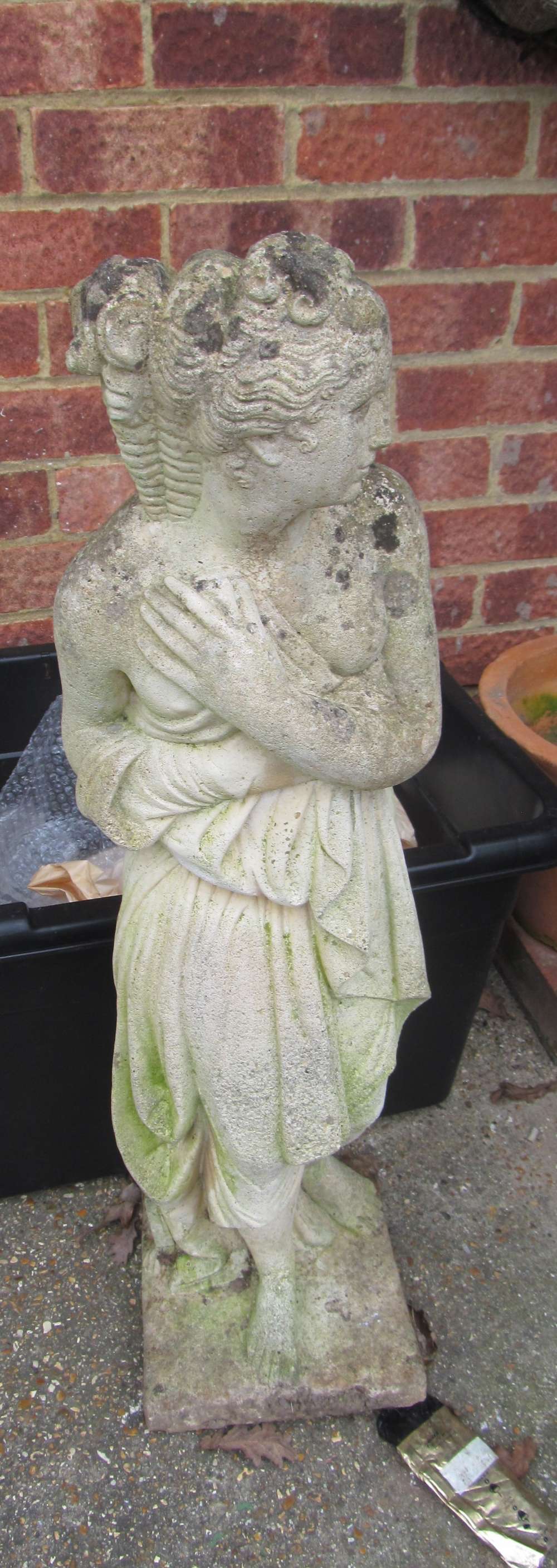 A stoneware garden statue classical lady