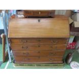 A 19th Century bureau fitted pigeon holes above three long drawers