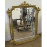 A gilt mirror with curved corners and outer pillars