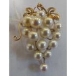 A pearl brooch in the form of a bunch of grapes on a mount marked K14