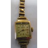 A ladies 9ct watch with 9ct bracelet strap