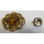 An oval Victorian brooch set topaz and a small brooch set white stone