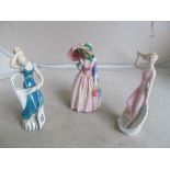 A Royal Doulton figure Miss Demure (umbrella a/f) and two Royal Doulton figures Seasprite and Nymph