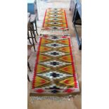 A pair of gold, brown and red geometric pattern rugs