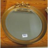 A circular gilt mirror