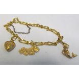A gold plated charm bracelet with three 9ct gold charms