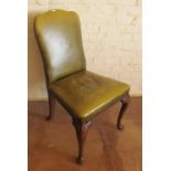 A 1920's green leather chair on oak cabriole legs