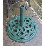 A garden parasol with green metal stand