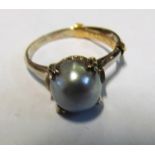 A pearl ring on mount marked K14