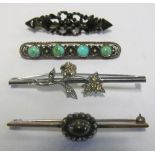 A Victorian jet bar brooch, turquoise and floral bar brooch and two other bar brooches