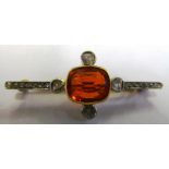 An Edwardian diamond brooch with central possible fire opal