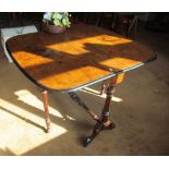 A Victorian walnut Sutherland table with black edging