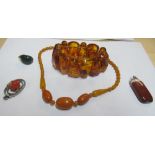 An amber necklace, bracelet and three pendants