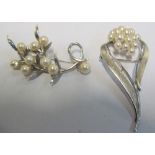 A pearl floral spray brooch and another stylish pearl brooch