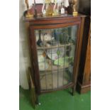 An Edwardian display cabinet with stained glass door