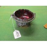 A plated sugar stand with red glass bowl