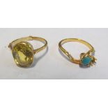 A yellow metal ring set citrine and another crossover ring set turquoise (one stone deficient)