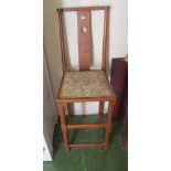 An Arts and Crafts style high chair with heart shaped design to back on turned supports