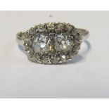 A platinum two stone diamond ring with illusion surround, size P