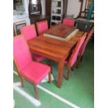 An Ercol table and six chairs with extra leaf