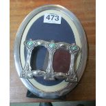 An oval silver photo frame and a silver and enamel small double photo frame