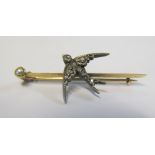 A gold and diamond swallow brooch with pearl end, 4.3g