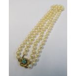A double strand pearl necklace with turquoise set clasp marked 14k