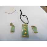 A gold and jade pendant and earrings set