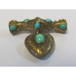 A turquoise brooch with heart