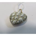 A gold coloured pearl and diamond heart pendant