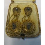 A pair of ornate filigree drop earrings set small diamonds
