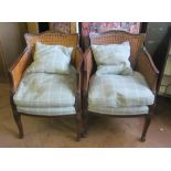 A pair of mahogany bergere chairs