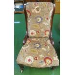 A Victorian nursing chair upholstered in paisley style velvet