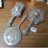 An Art Nouveau silver backed hand mirror and matching brush and another mirror
