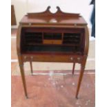 A 19th Century mahogany cylinder top desk with pull-out writing surface swan neck gallery on