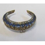 A crescent sapphire and diamond brooch