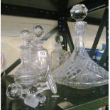 Four glass decanters and a ships decanter