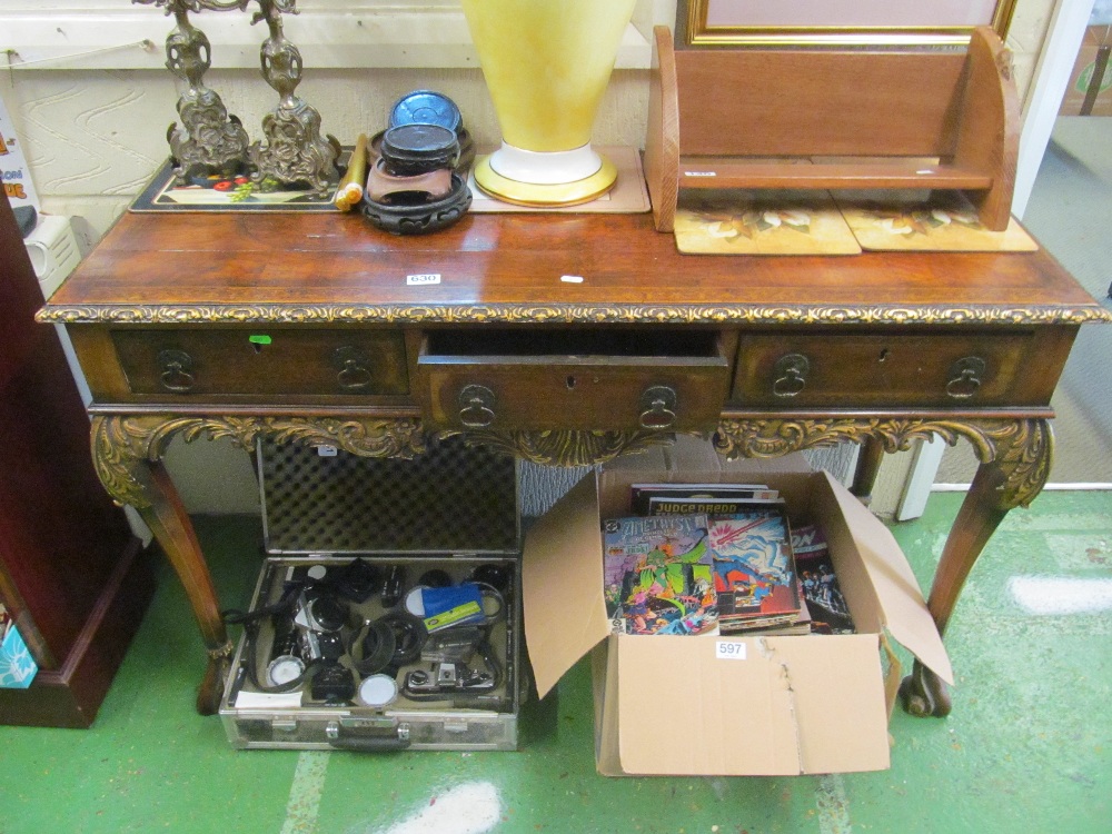 A late 19th Century walnut console table of three drawers on carved cabriole legs and scroll feet