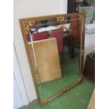 A wall mirror with gilt corners