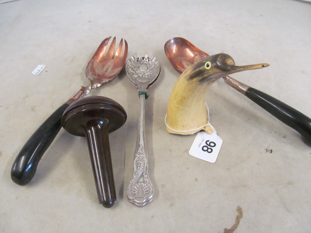 Two pairs salad servers, horn penguin and a sewing mushroom