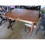 A retro extending dining table and chair
