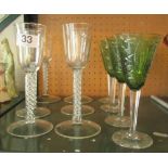 A set of six white airtwist stem glasses and four green drinking glasses