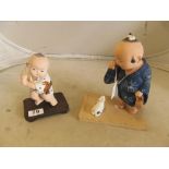 A Japanese bisque pottery figure boy with fishing rod and another boy crying over a shoe with dog