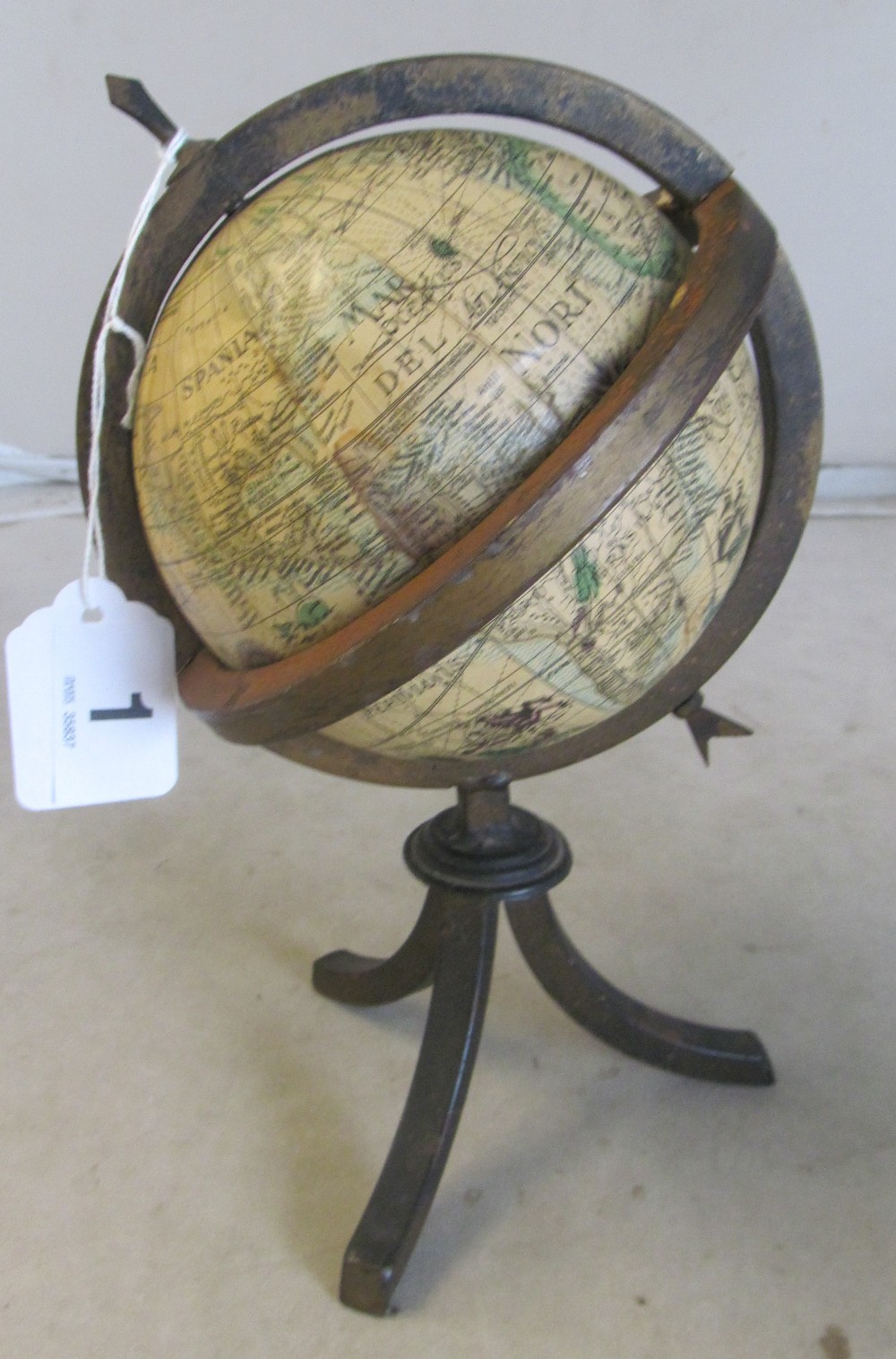 A small globe in metal stand