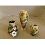 A Moorcroft daisy vase and two Moorcroft vases
