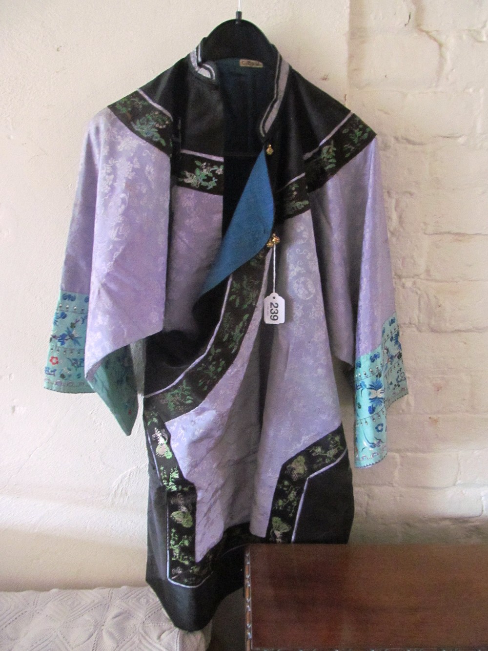 An oriental black and purple kimono style jacket with green embroidered sleeve panels of butterflies