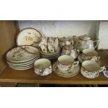 A pretty satsuma teaset six place setting with cups, saucers, plates, teapot, milk jug and sugar