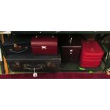 A vintage suitcase and four large jewellery cases