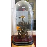 A skeleton clock under glass dome